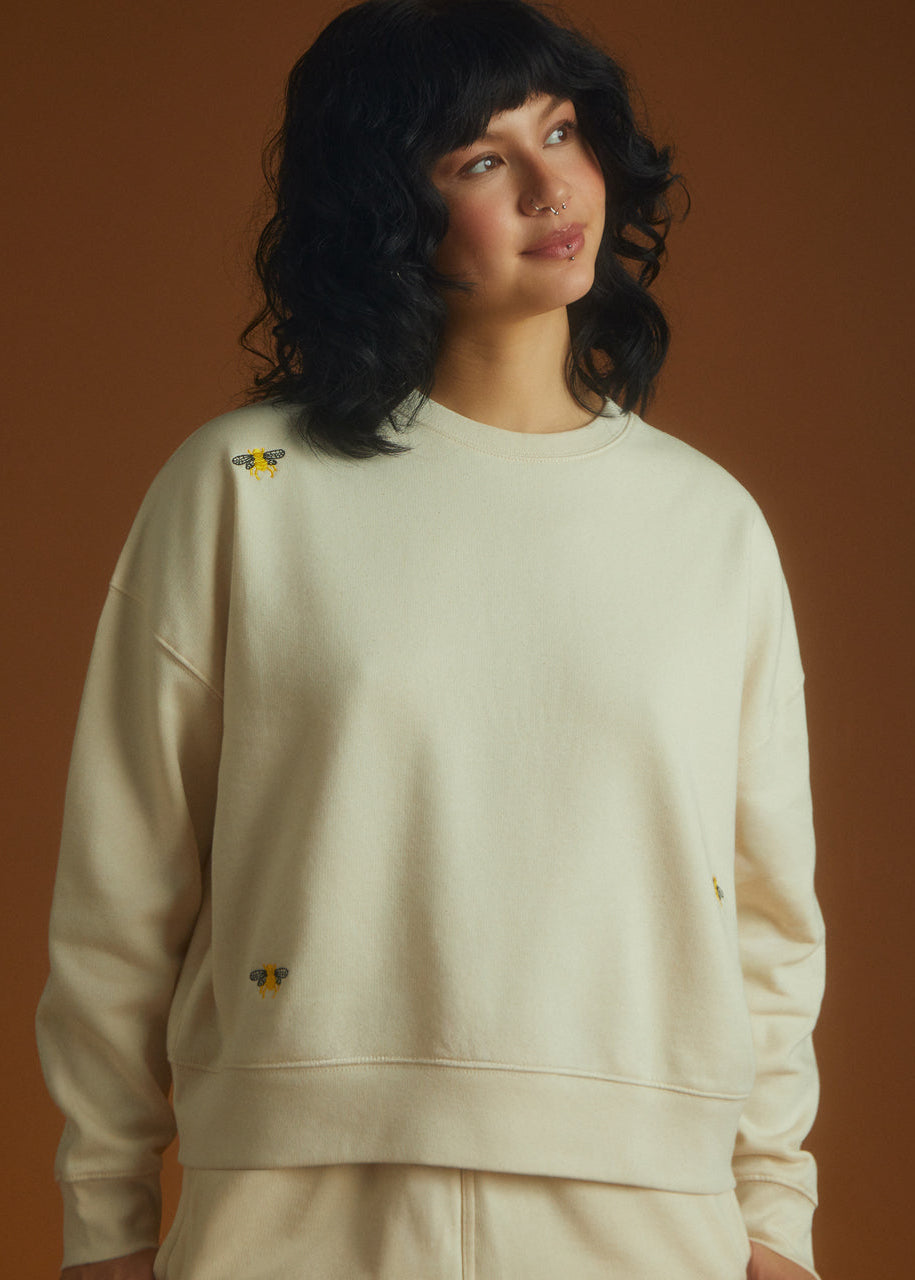 a girl wearing a sweatshirt with bees