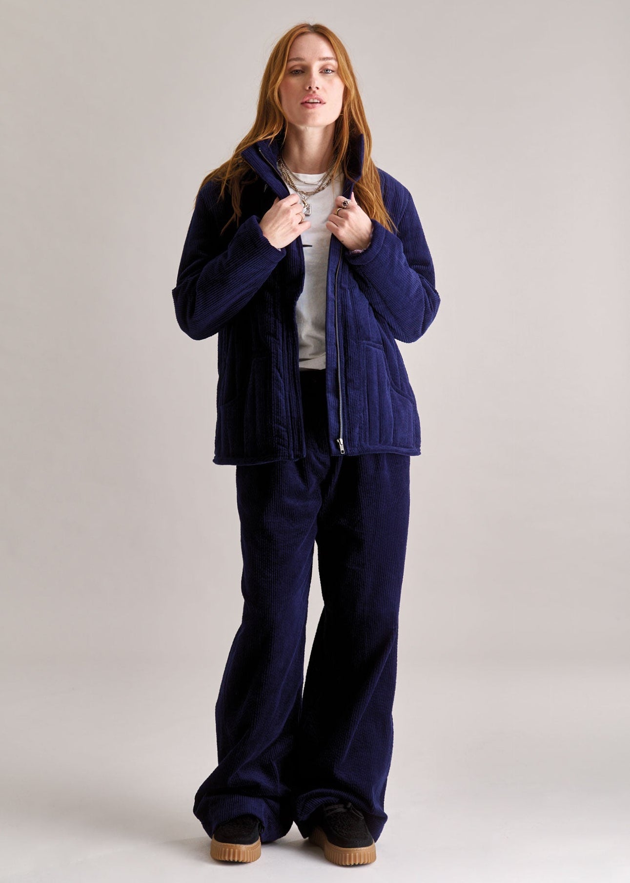 Woman wearing a blue outfit on a plain background