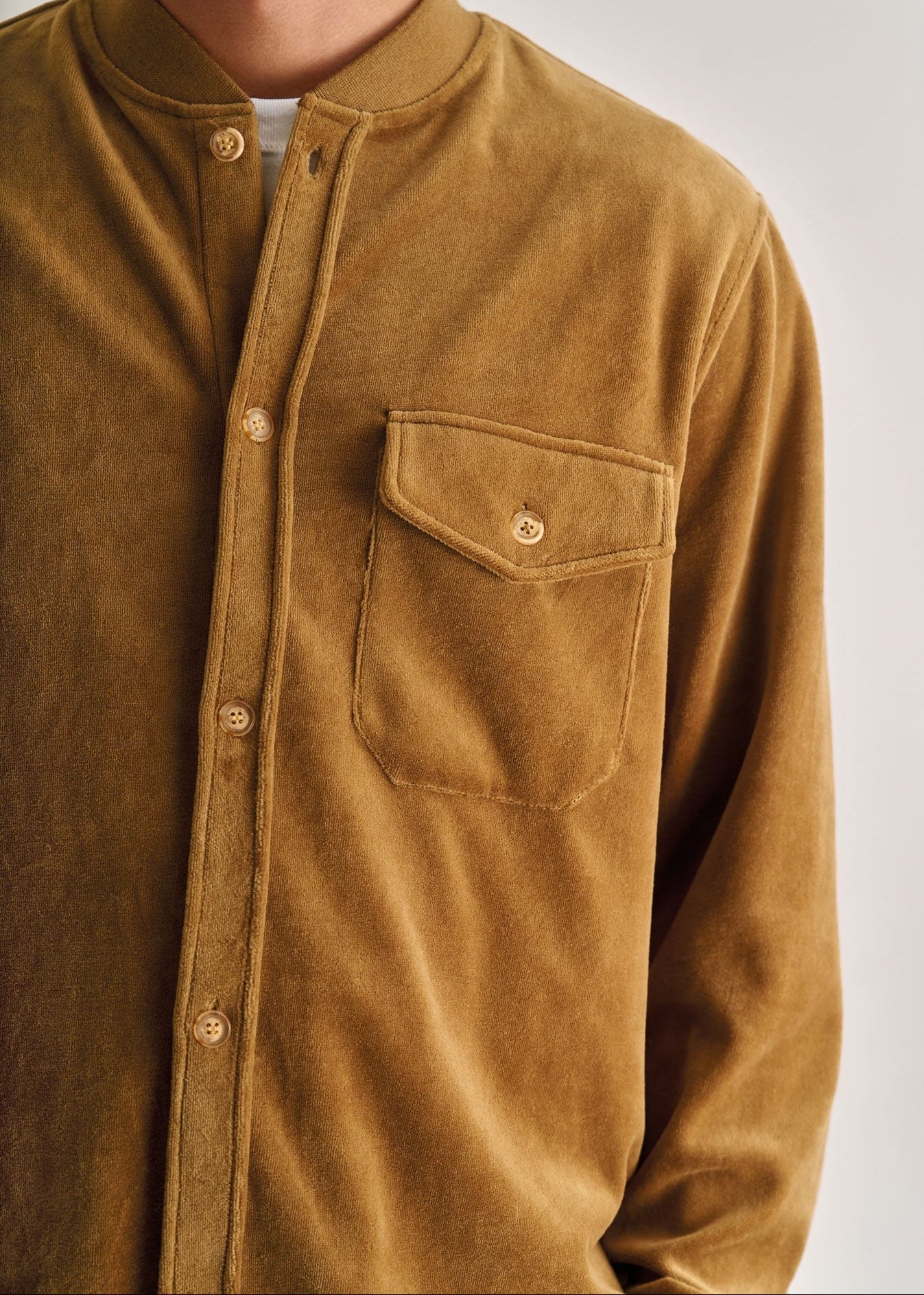 Brown corduroy shirt with a pocket on a white background