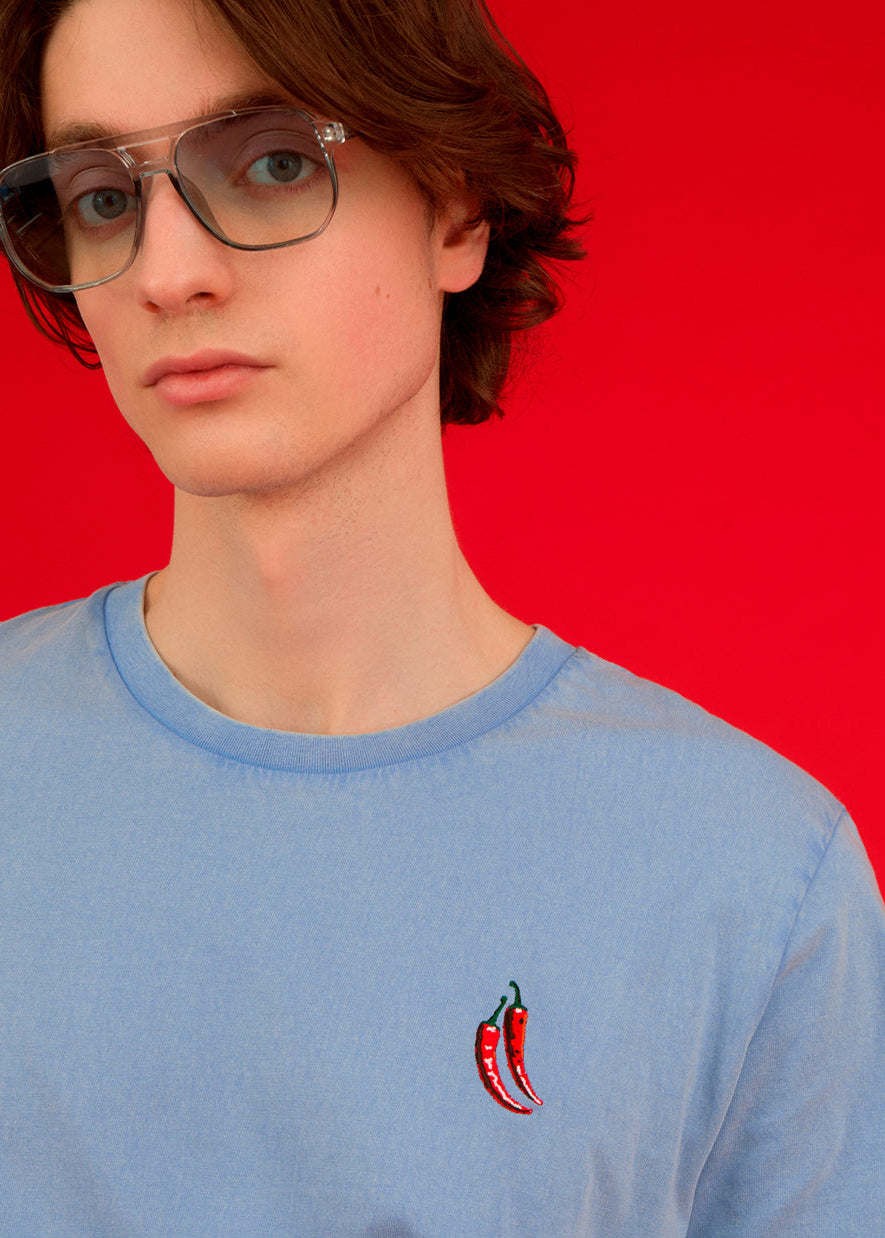 a men wearing a blue top with chilli embroiderey 