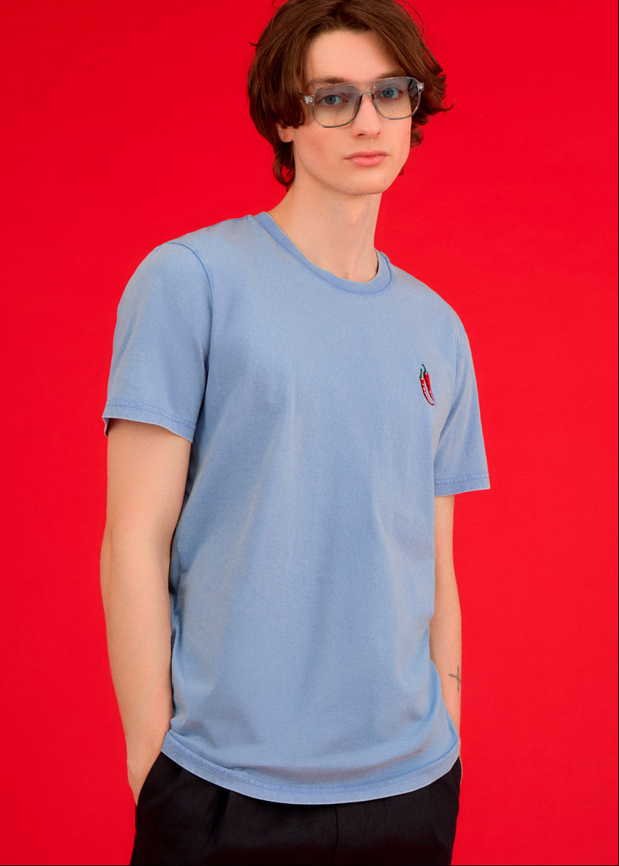 a men wearing a blue top with chilli embroiderey 