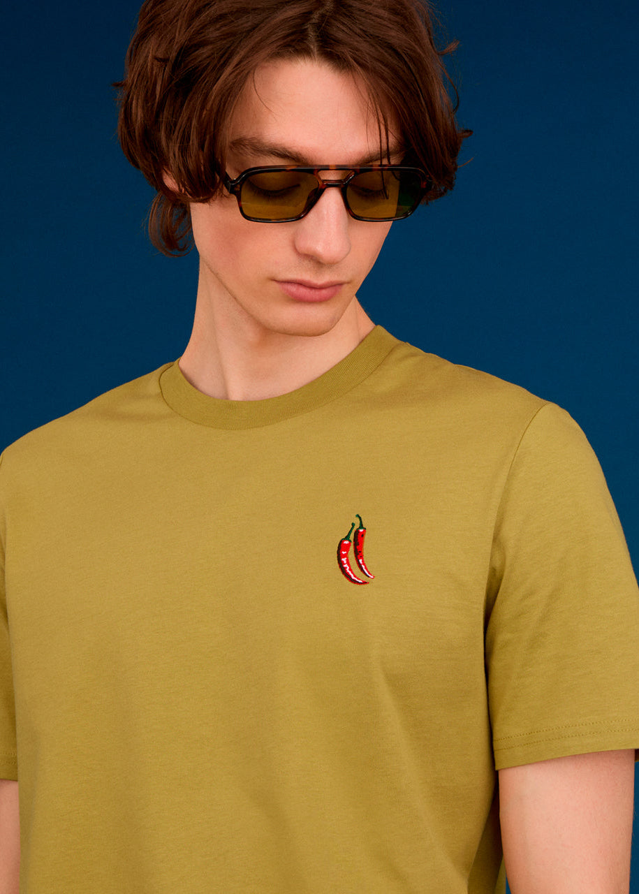a men wearing a green top with chilli embroidery  