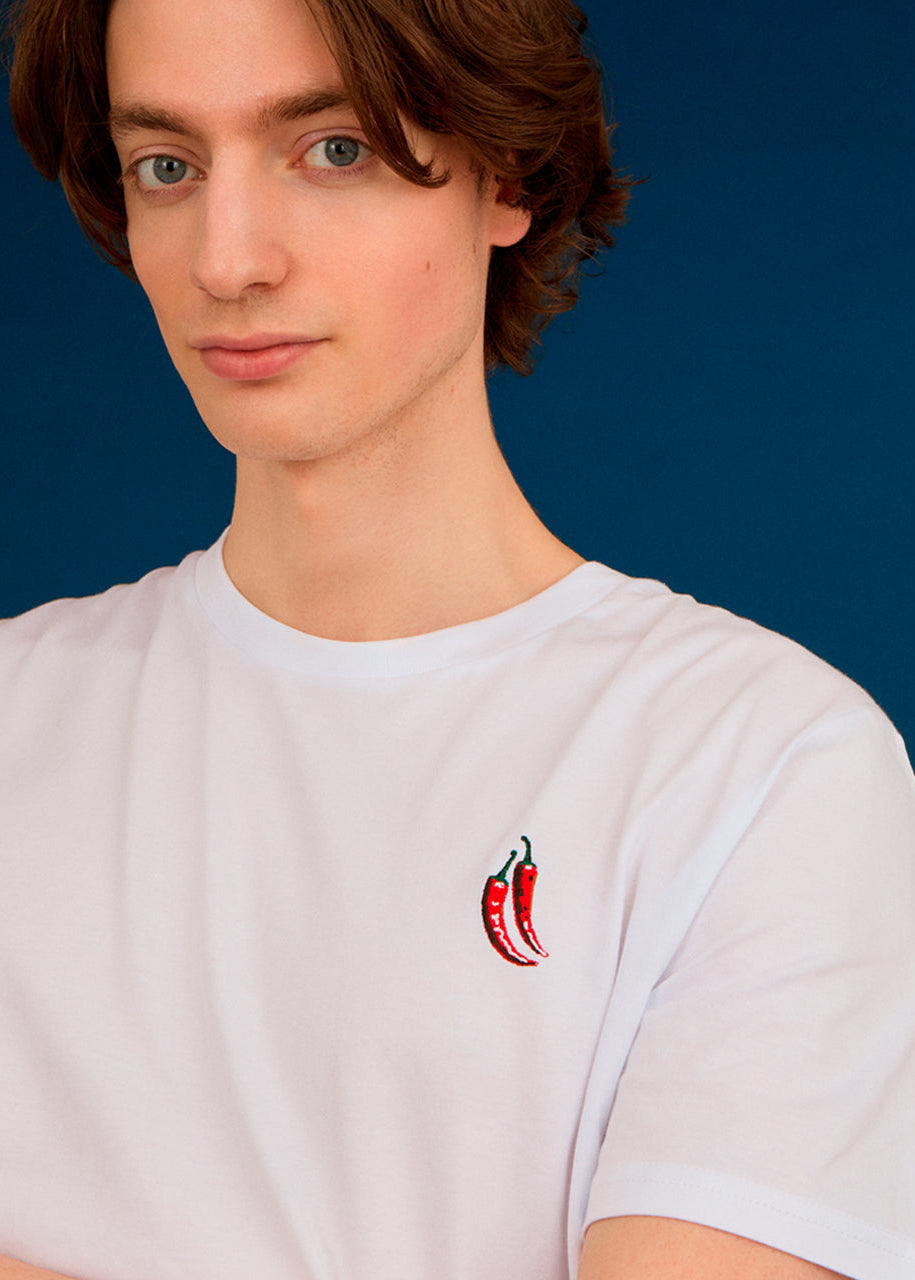 a men wearing a white top with chilli embroiderey 