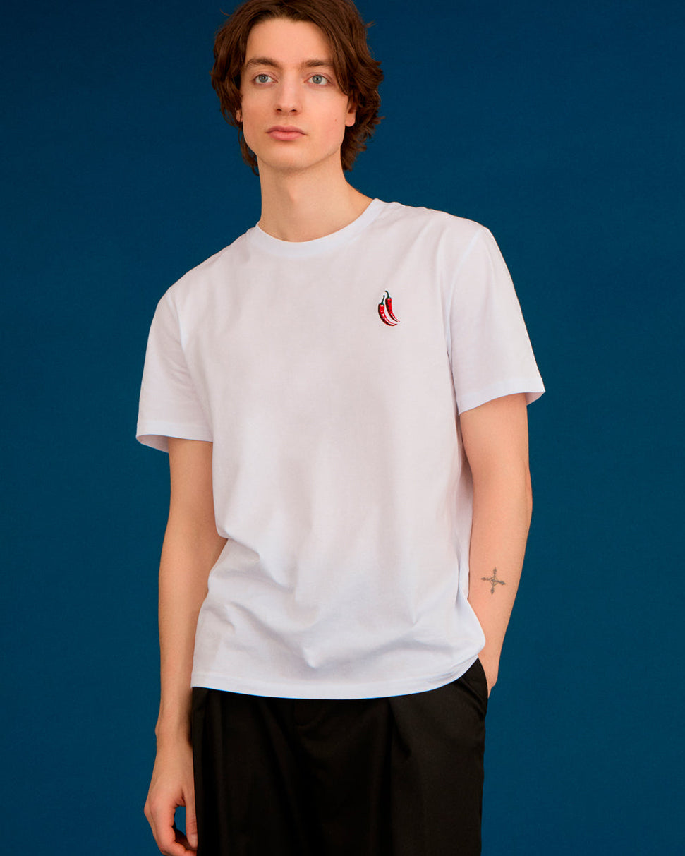 a men wearing a white top with chilli embroiderey 