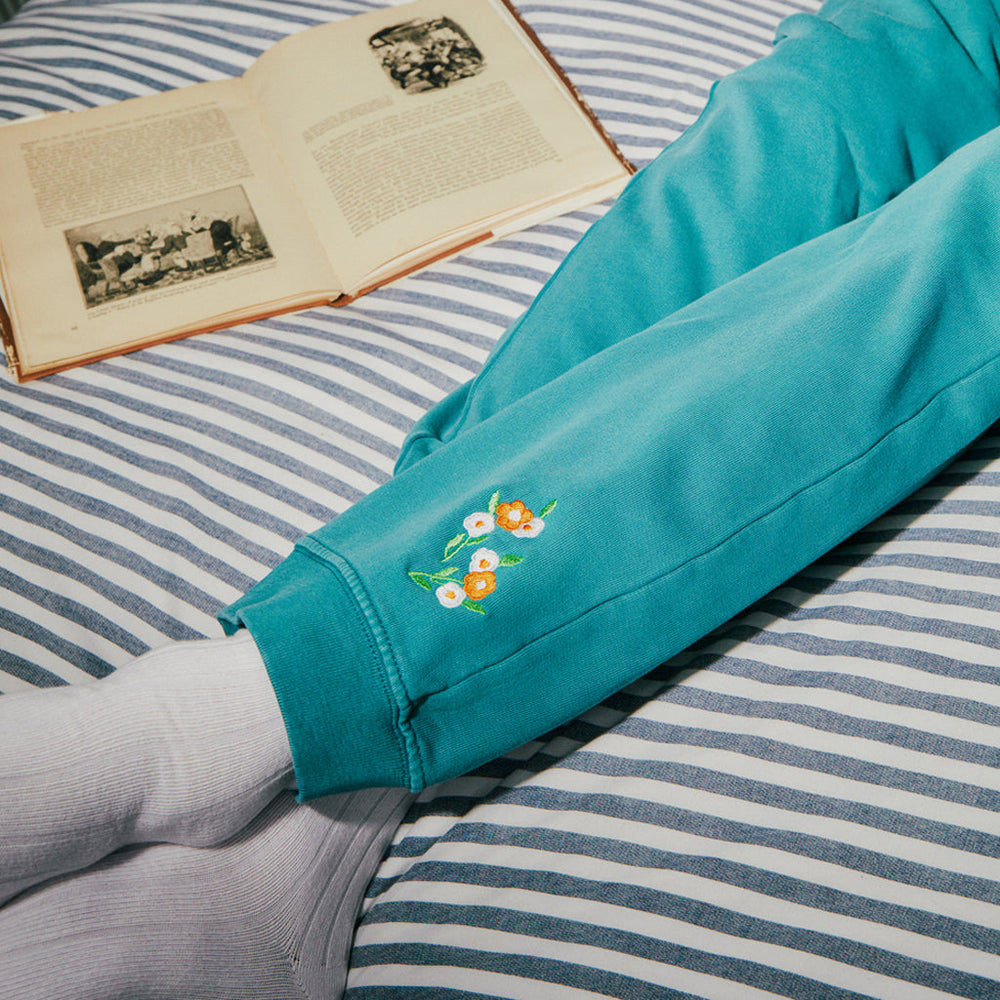 
                  
                    closeup of floral embroidery on joggers
                  
                