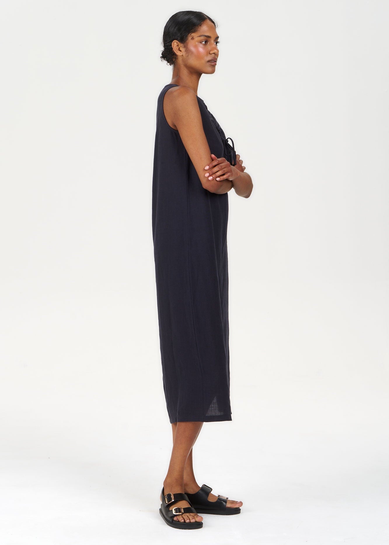 Woman wearing a black sleeveless dress on a white background