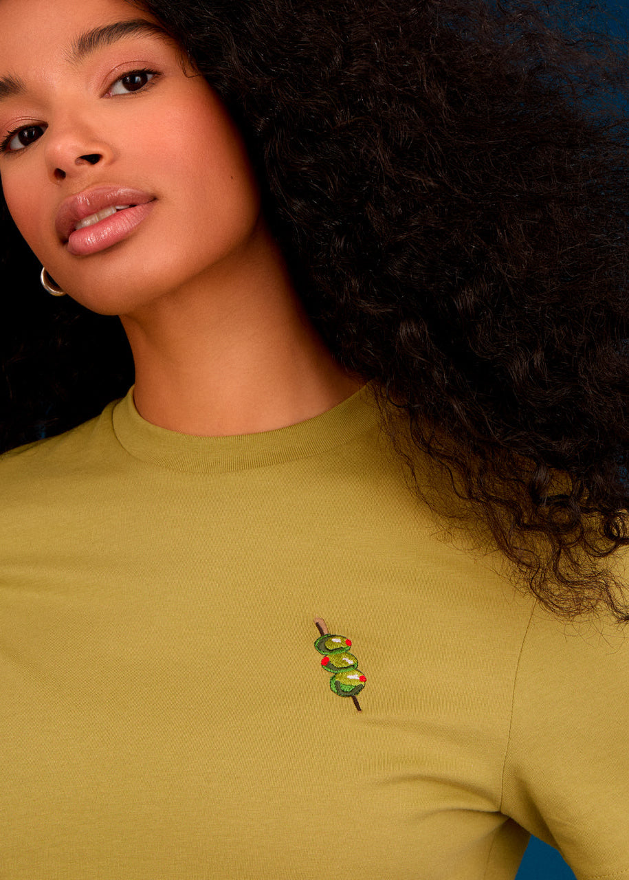 a women wearing a green top with olives embroidery 