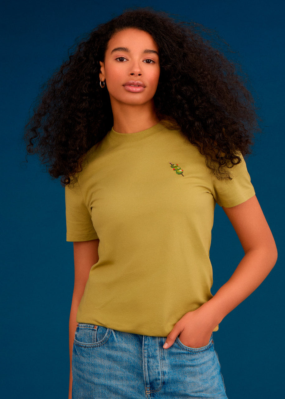 a women wearing a green top with olives embroidery 