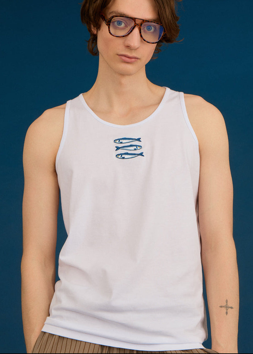 a man wearing a tank top with embroidery on