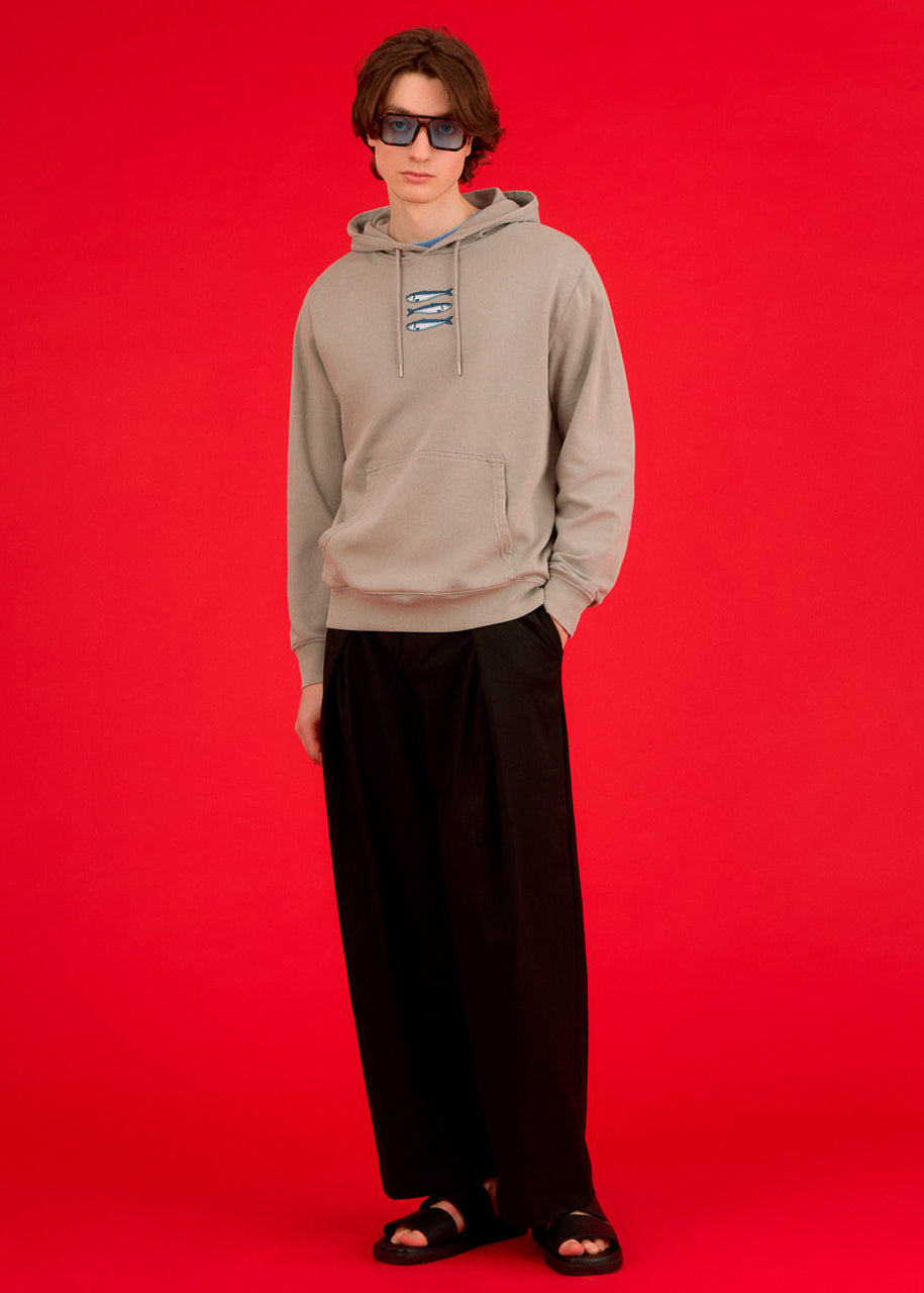 a man wearing an ingmarson hoodie with sardines embroidered  