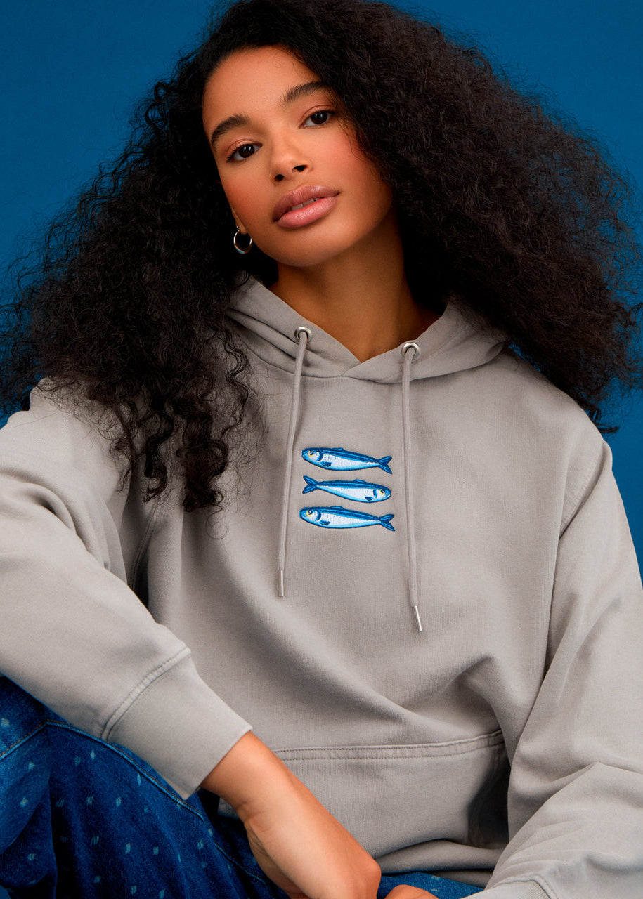 a women wearing an ingmarson hoodie with sardines embroidered  