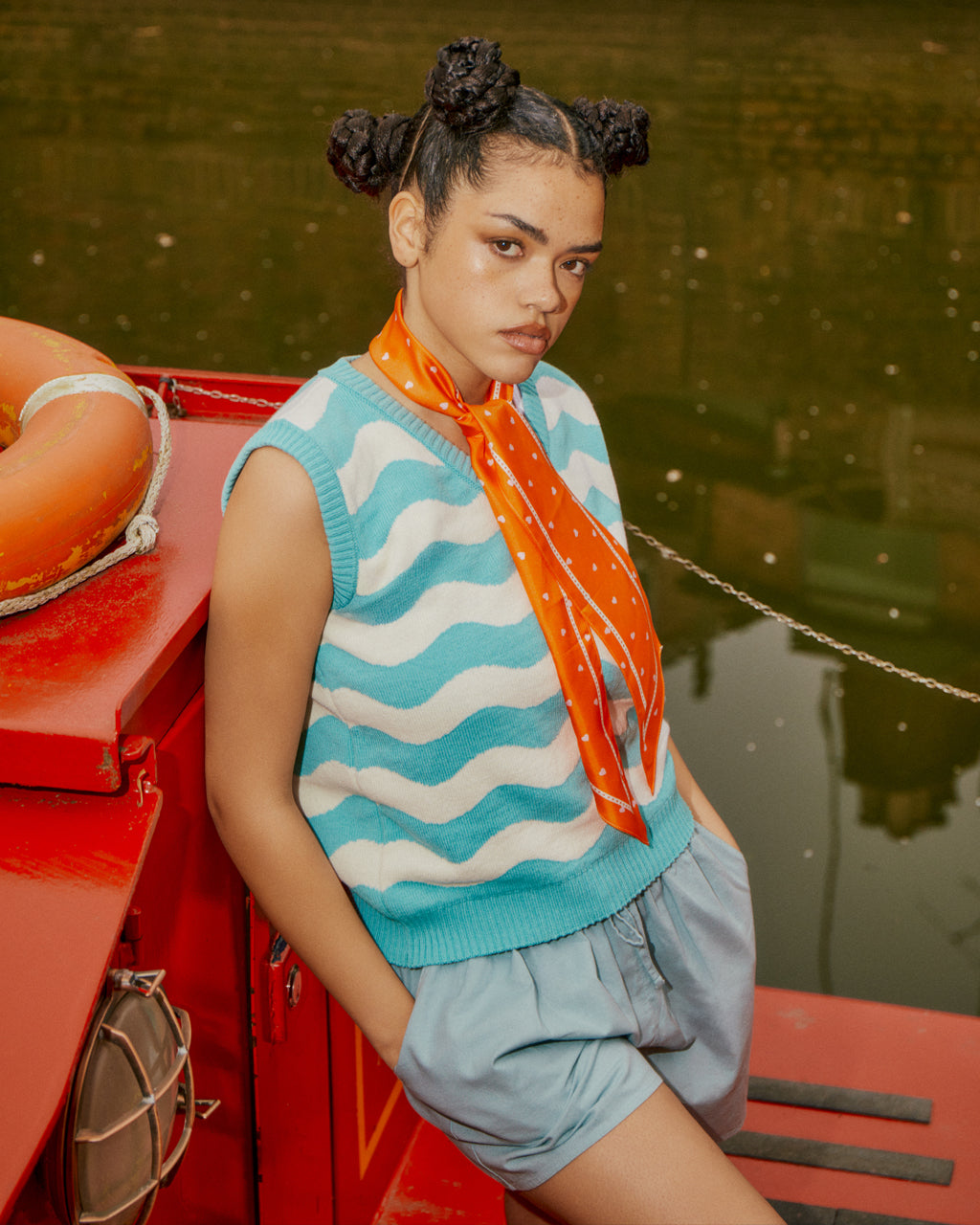 a girl standing in front of a boat