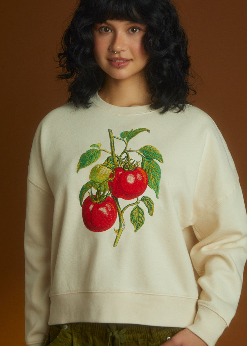 a women wear a sweatshirt with tomato embroidered 
