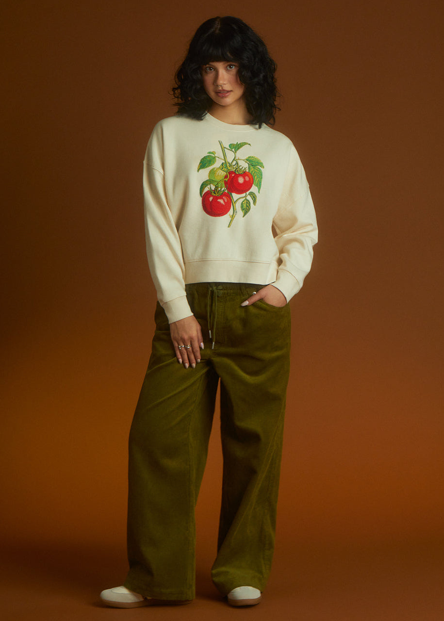 a women wear a sweatshirt with tomato embroidered 