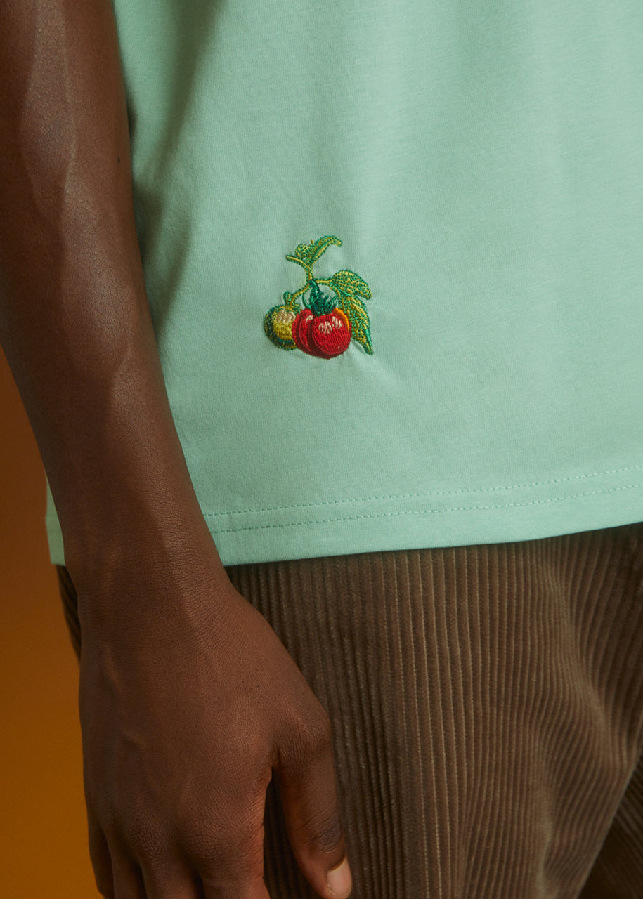 a green top with tomatos embroidered