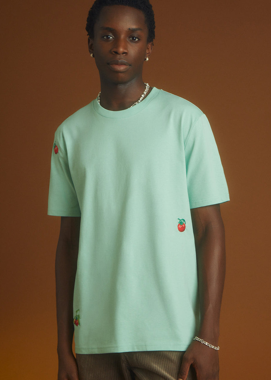 a green top with tomatos embroidered