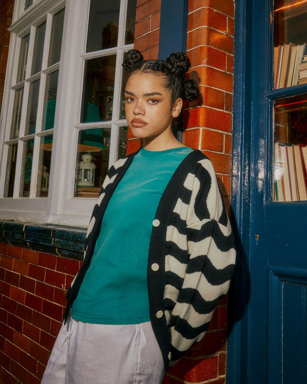 a person wearing a blue shirt standing in front of a pub